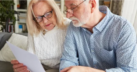 couple carefully reviewing their expenses